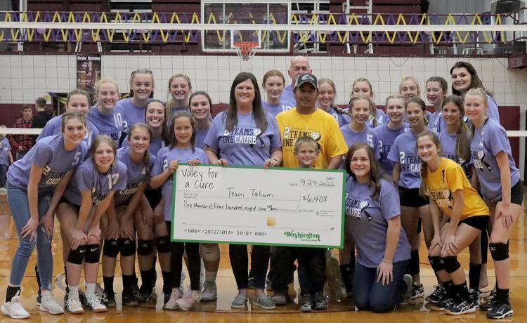 The Dieterich volleyball team poses for a portrait with Janelle Garcia and Travis Garcia after a volleyball match against Altamont on Sept. 29, at Dieterich High School. Both teams raised $6,408 for Janelle and Travis’ son Tatum’s cancer treatment.