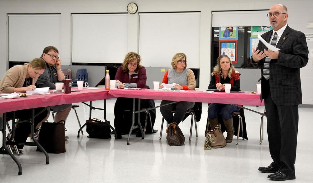 Members of the Dieterich and Effingham school boards listen as David Ardrey, standing, of the Association of Illinois Rural and Small Schools discusses the teacher shortage occuring in smaller school districts during the second meeting of the members of the Effingham County school boards Thursday at Dieterich Jr.-Sr. High School.